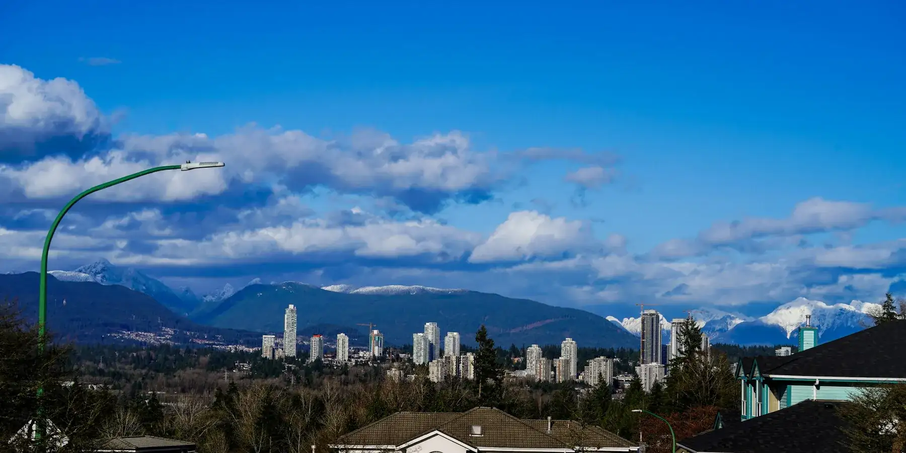 Aerial view of Greater Vancouver neighbourhoods and mountains