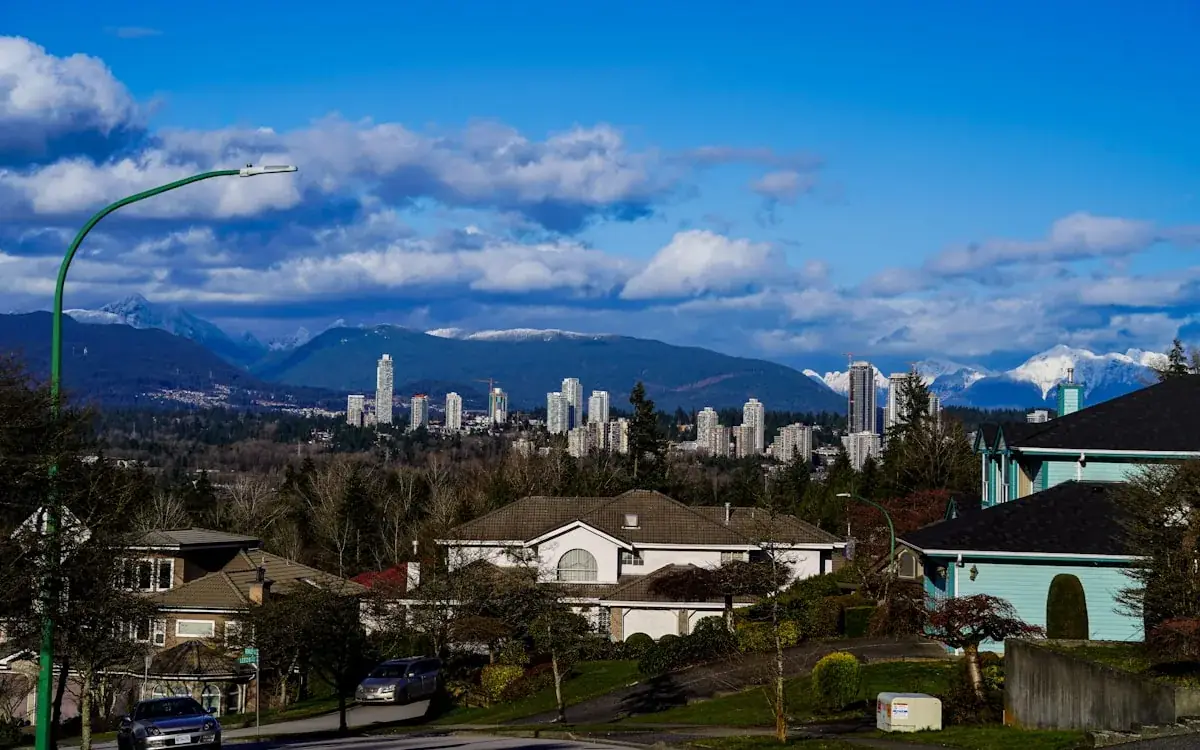 Vancouver-area hillside suburb with mountains and skyline in the distance