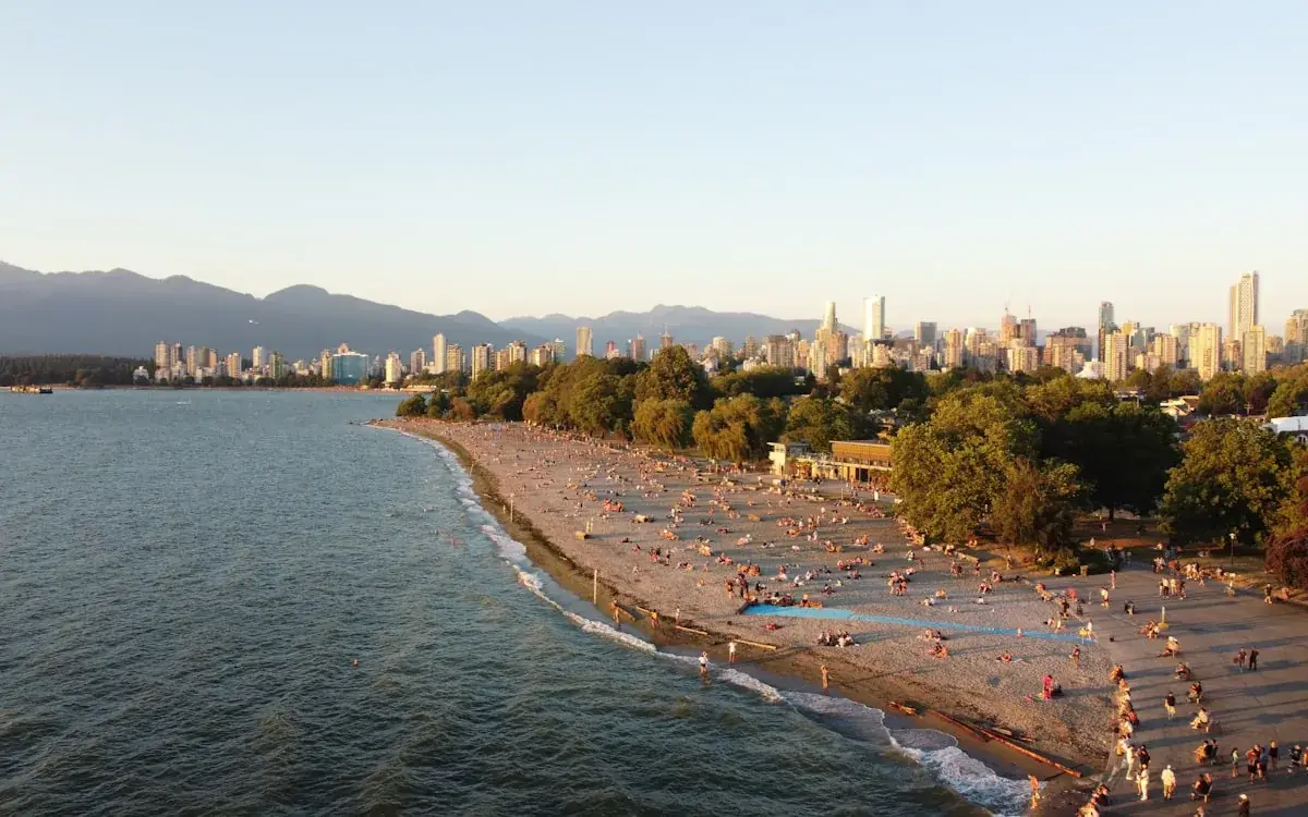 Kitsilano beach curving toward the Vancouver skyline