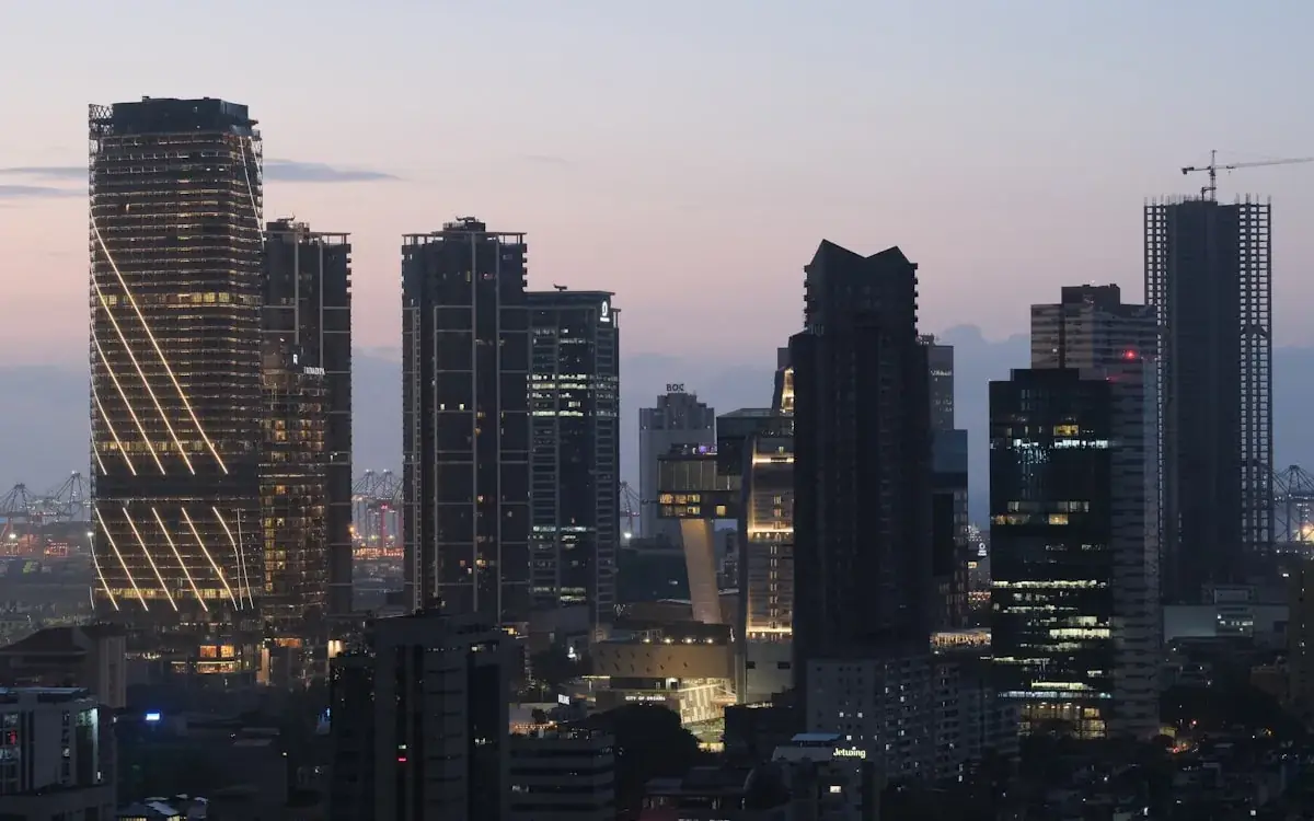 Cluster of high-rise towers lit against a dusk sky