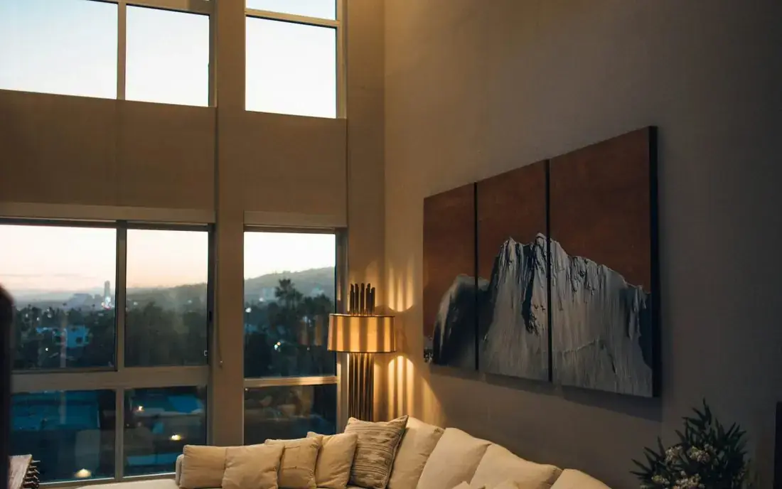 Warm living room with floor-to-ceiling windows in an Ambleside rental