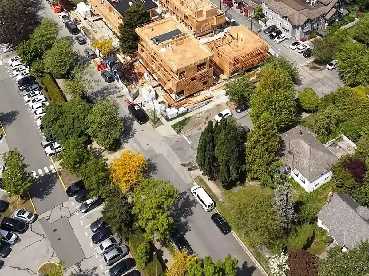 Tree-lined Vancouver West Side neighbourhood near WREN with mountains beyond